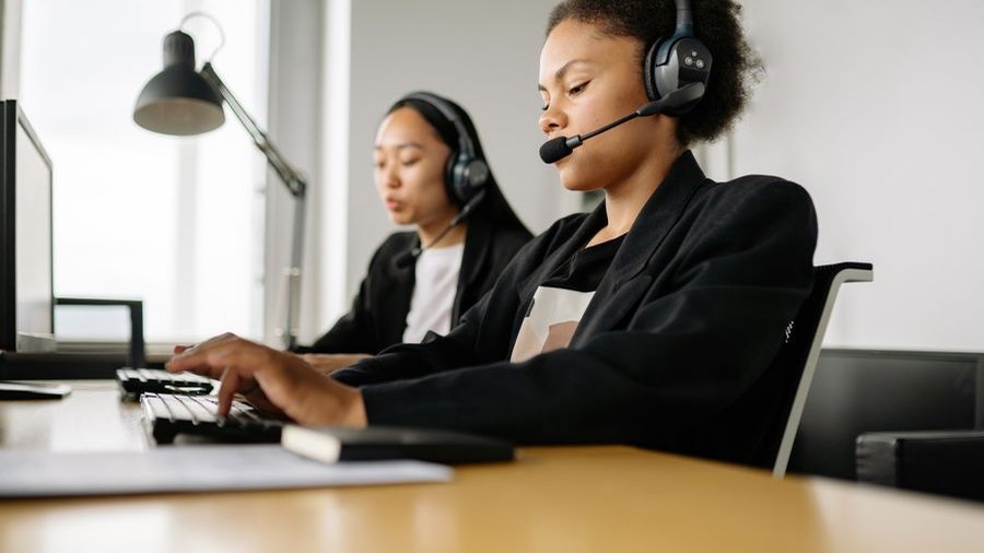 Two call representatives working at their desks