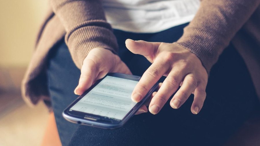 A person holding a phone with a missed call